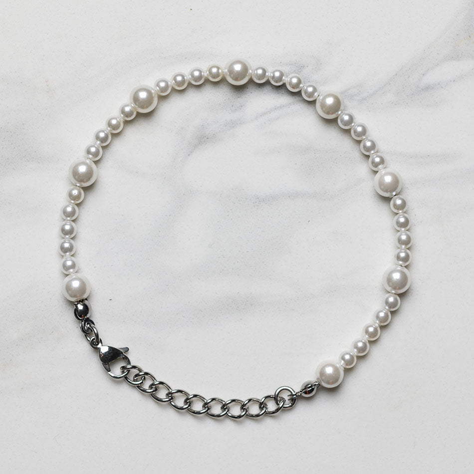 Our Asymmetric Pearl Bracelet has been crafted using different sized polished white pearls, along with the finest silver hardware to hold it all together.